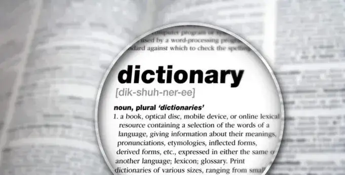 A magnifying glass over a dictionary page